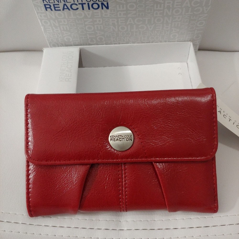 Kenneth Cole Reaction red wallet snap closure.